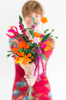 person holding bouquet of flowers