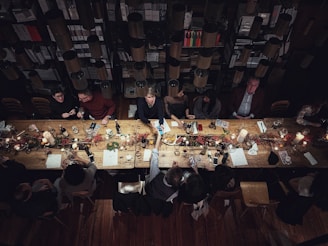 high-angle photography of people beside table