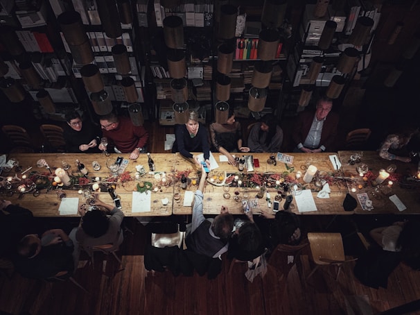 high-angle photography of people beside table