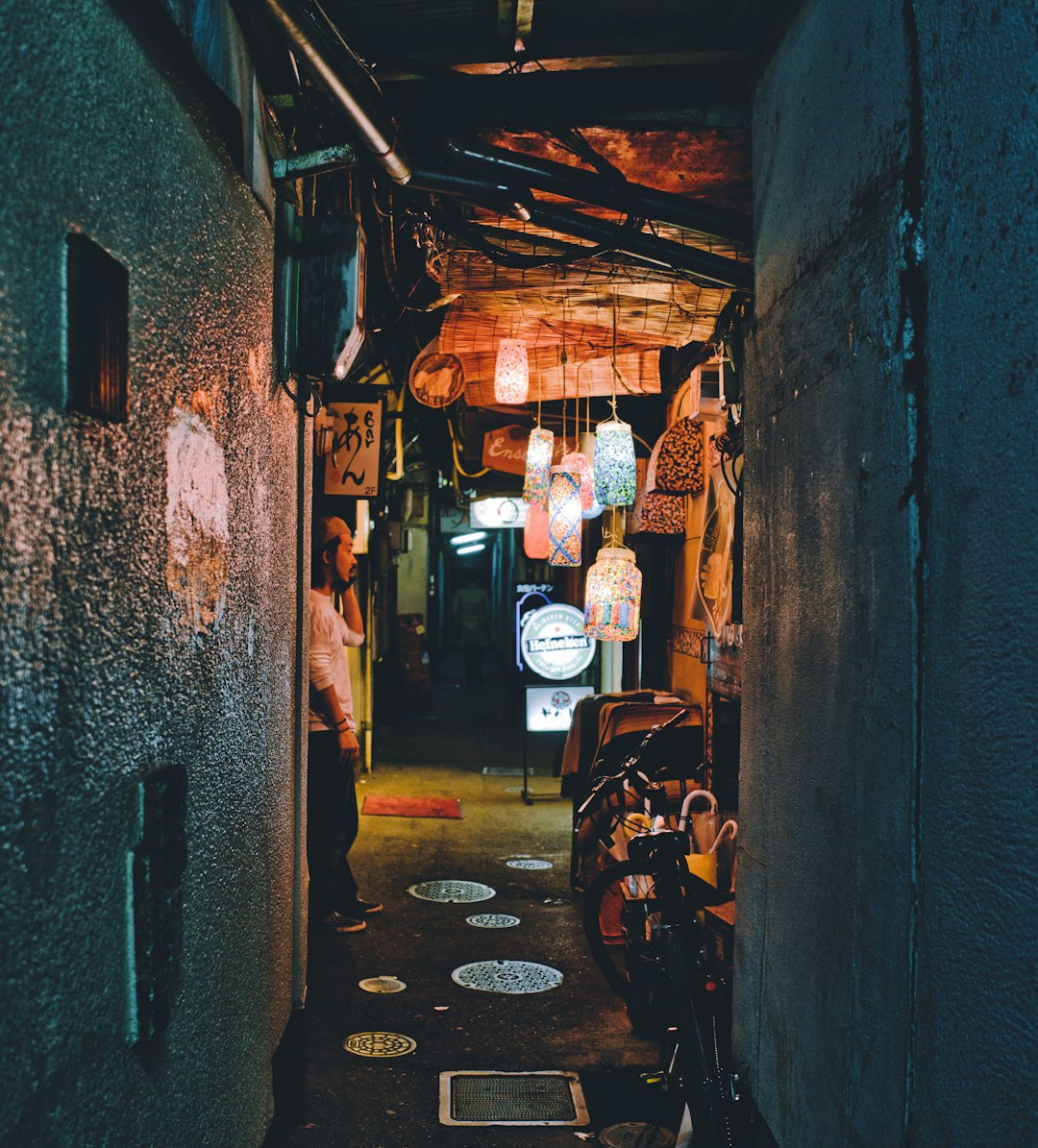 man standing front of wall at night