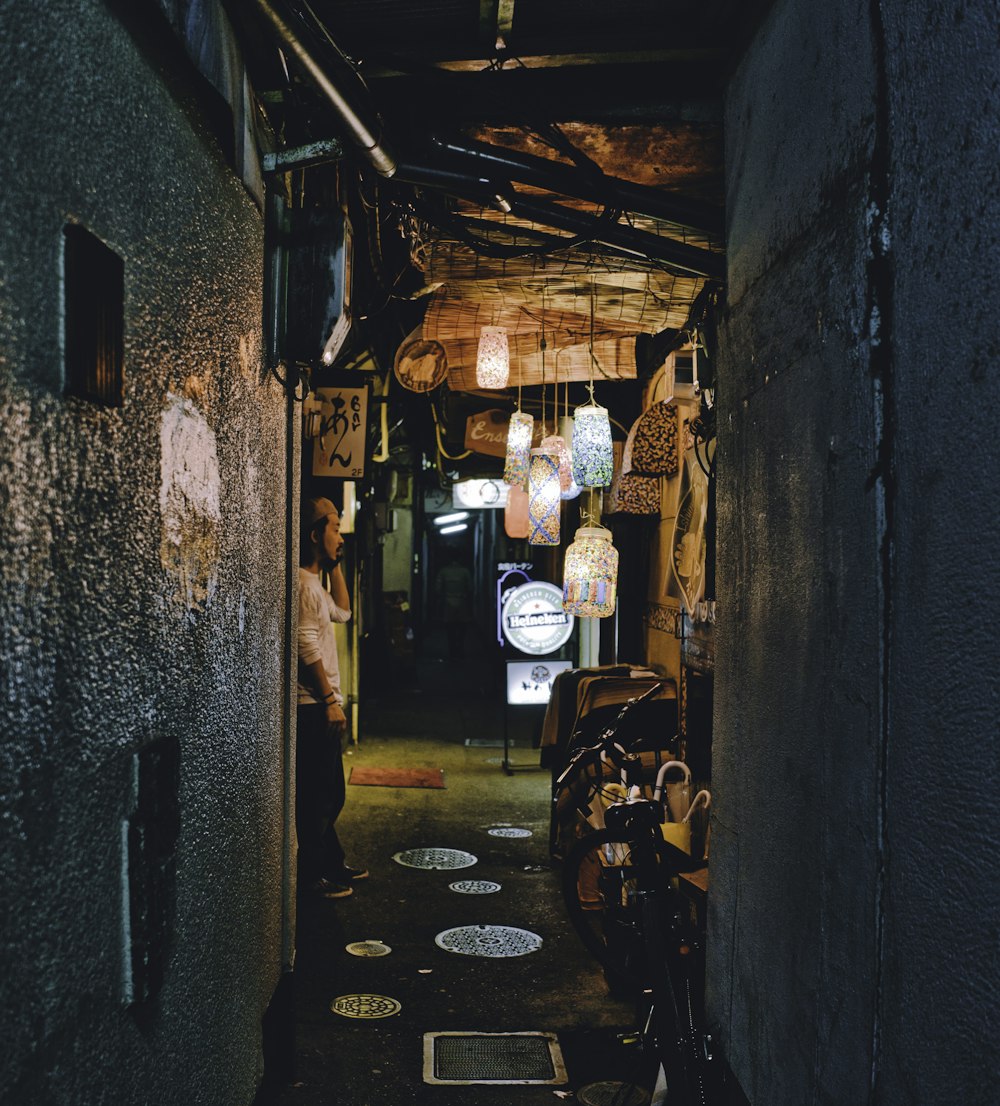 man standing front of wall at night