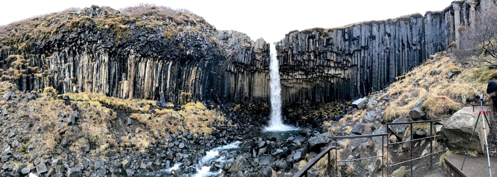 gray and black rock with waterfalls