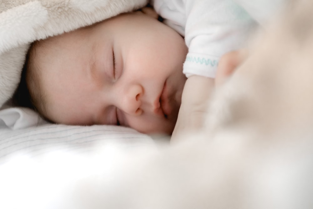 selective focus photography of sleeping baby