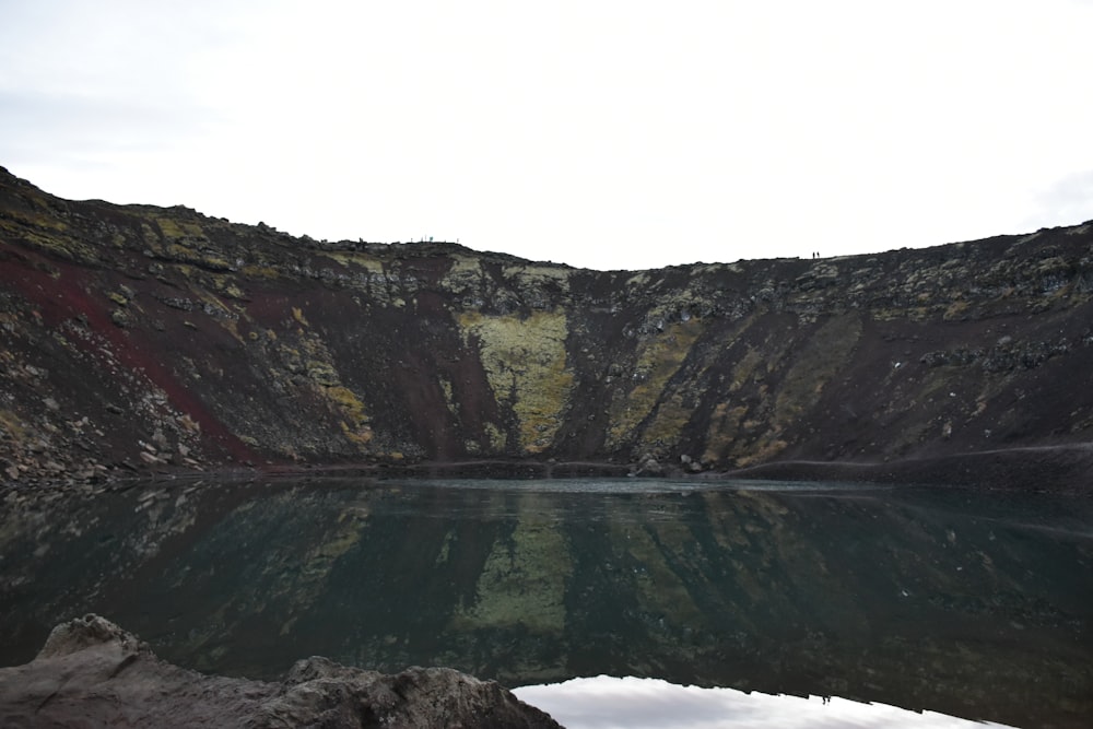 body of water and land during day