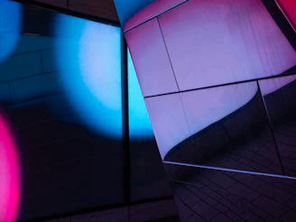 Close-up of a 3D light mapping simulation on a dark architectural surface with neon cyan highlights.