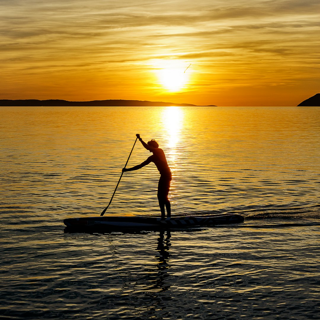 man on kayak during sunset