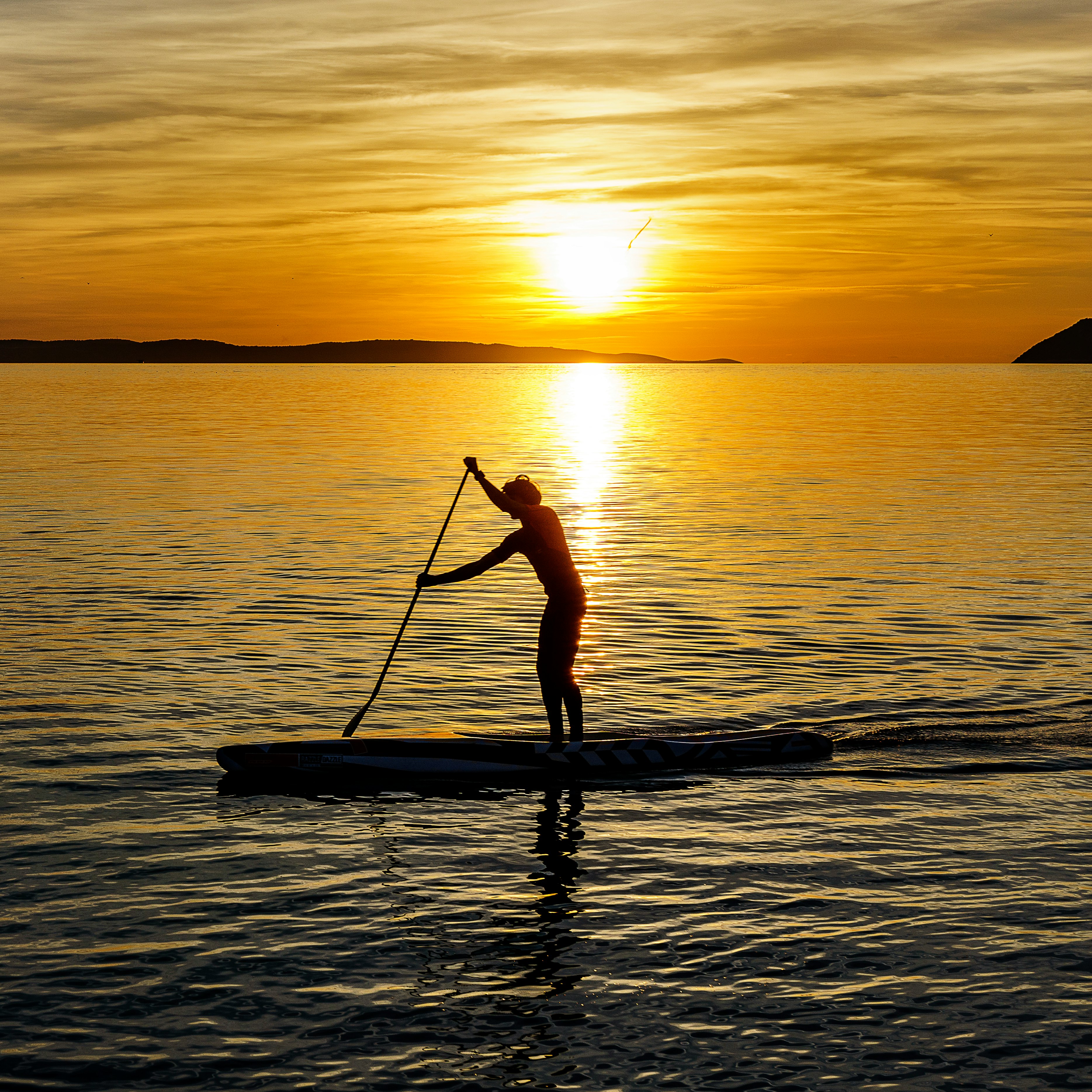 man on kayak during sunset