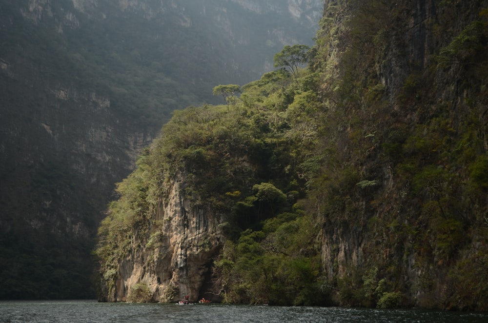 body of water beside hill