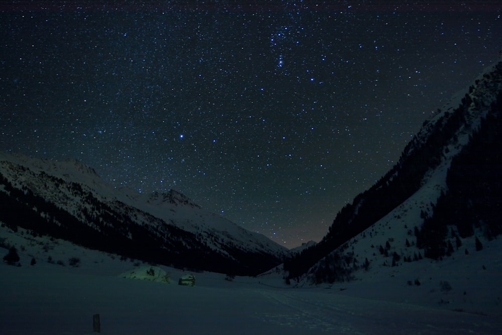 snow covered mountain under the starry night