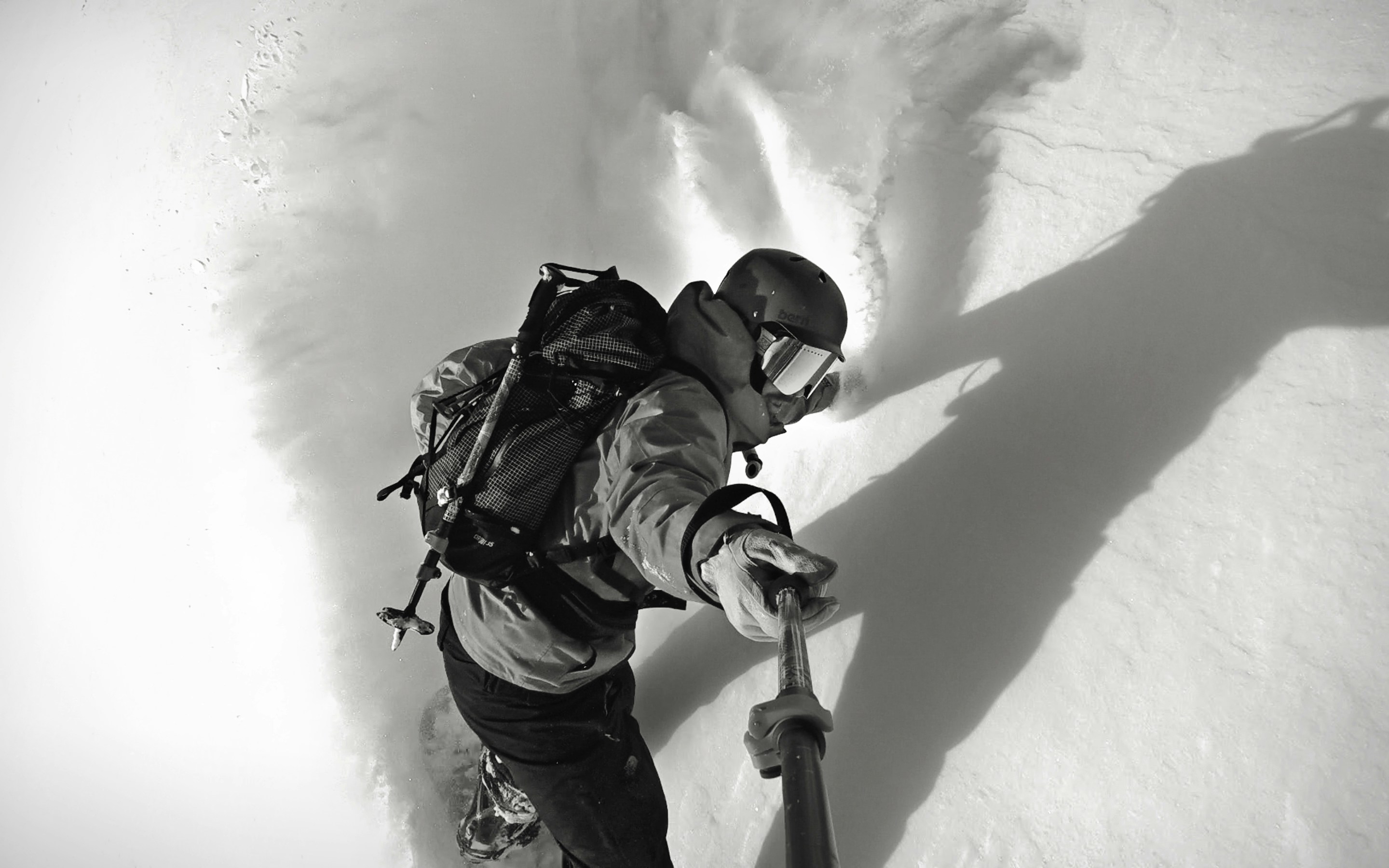 man wearing snow hiking outfit taking a selfie using monopod, first turns down the untracked face of Steven’s peak in alpine county, CA Dec. 2nd 2018 temperatures in the teens and great turns to be had. photo and rider: Blake Weyland