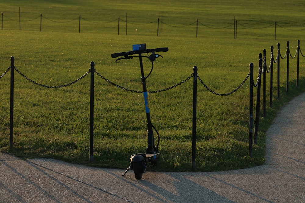 blue and black kick scooter near green field