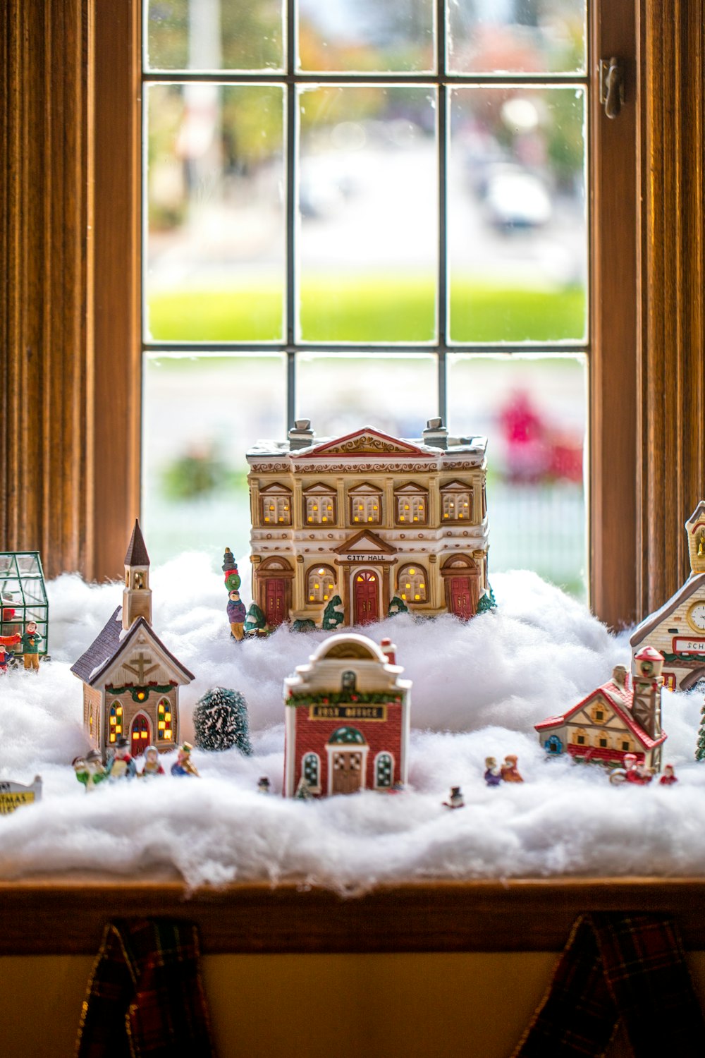ceramic Christmas village displayed by the window
