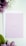 A light pink card with the text 'What God has joined together, let no one separate. Mark 10:9' is placed on top of a white envelope. Surrounding the card are purple and white flowers with green leaves, all set against a soft white background.