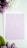 A light pink card with the text 'What God has joined together, let no one separate. Mark 10:9' is placed on top of a white envelope. Surrounding the card are purple and white flowers with green leaves, all set against a soft white background.