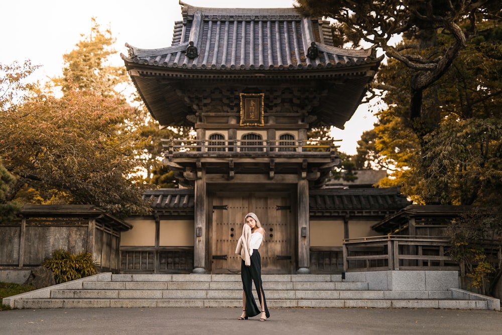 woman standing near brown building