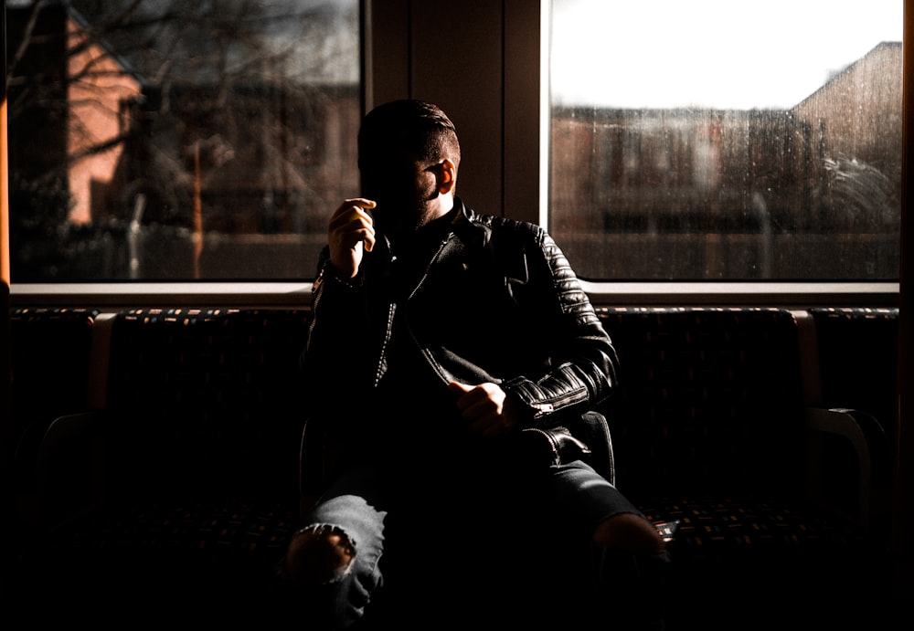 man leaning on wall