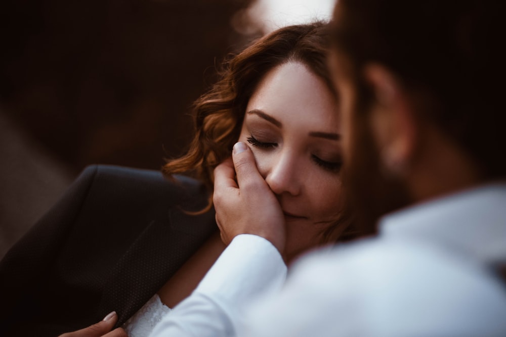 man holding face of woman