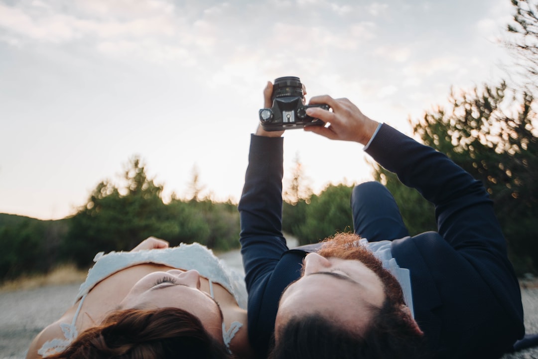 man and woman lying on ground