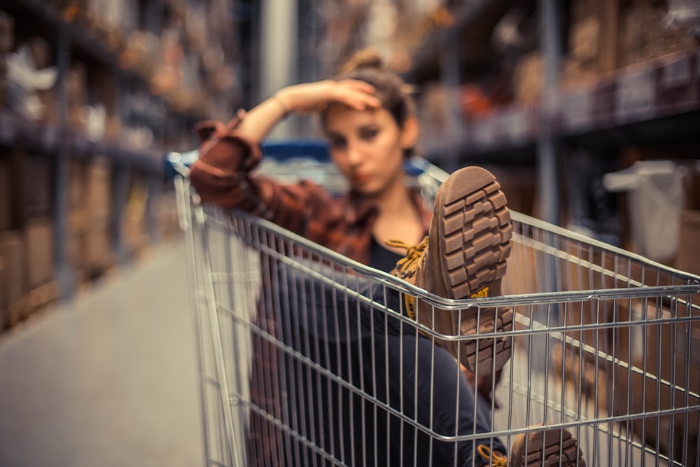 selective focus photography of woman sitting inside push cart