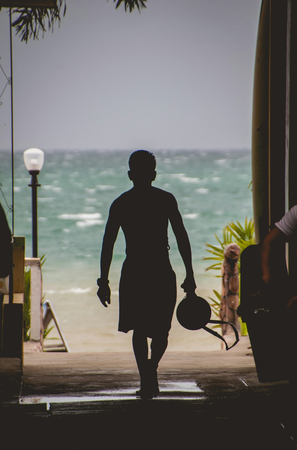 silhouette of man in front of ocean