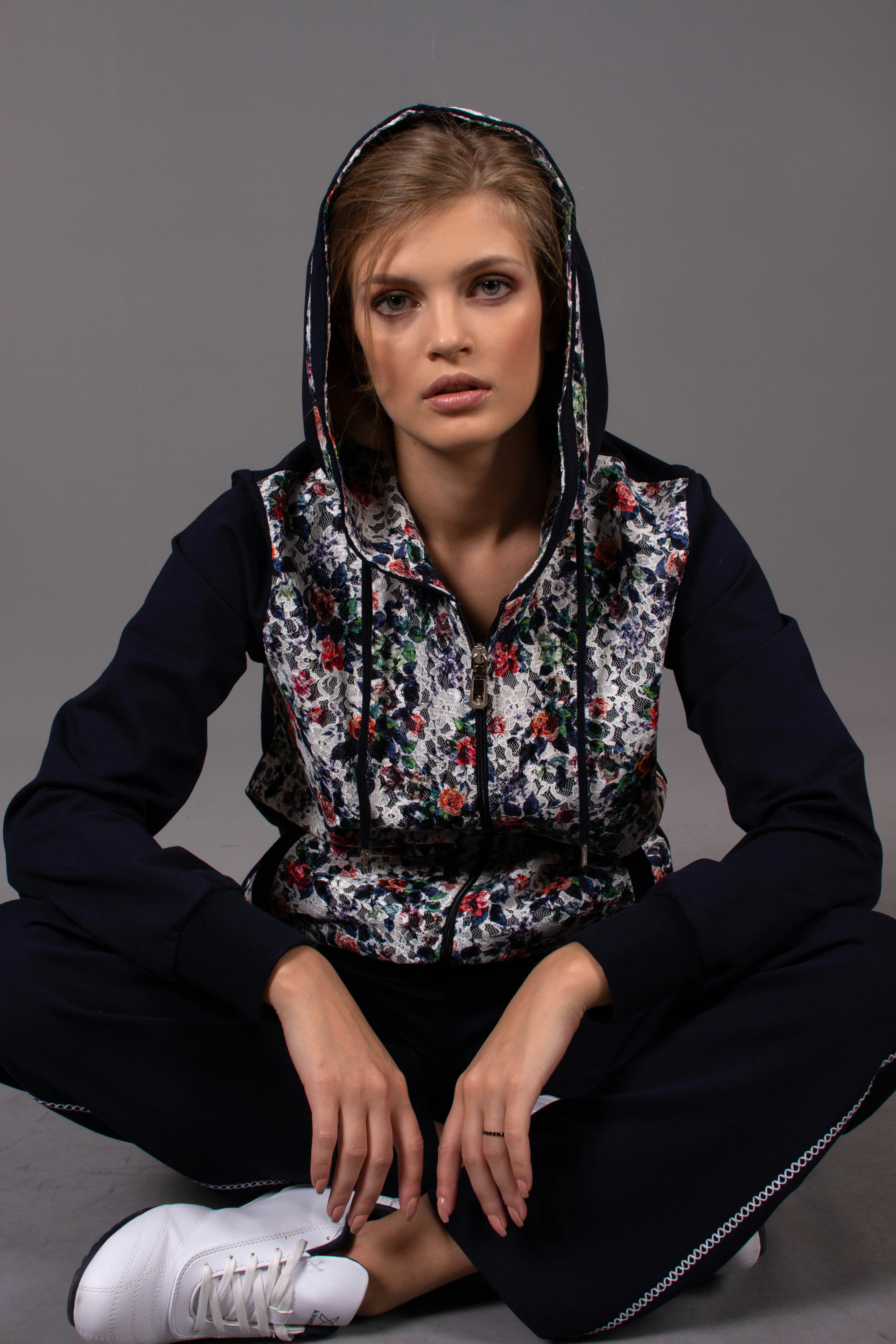 woman in black white red floral hoodie sitting