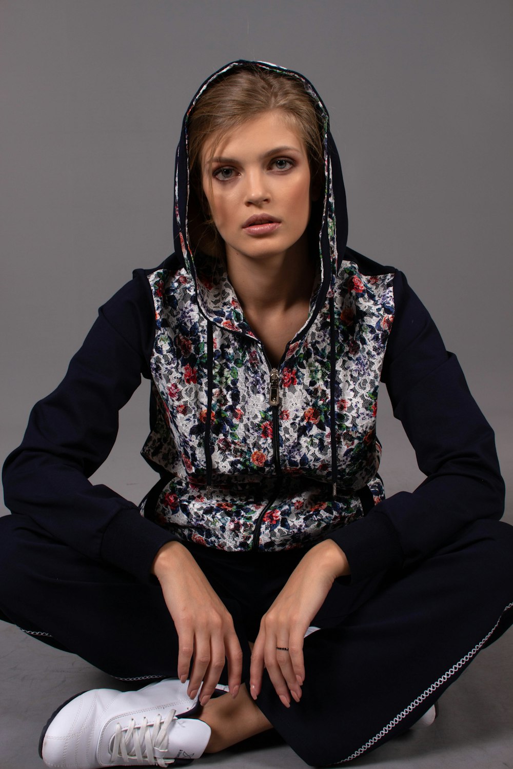 woman in black white red floral hoodie sitting