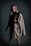 A cozy winter outfit featuring a long coat and turtleneck in neutral tones.