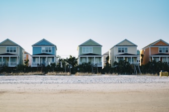 five assorted-color 2-storey houses