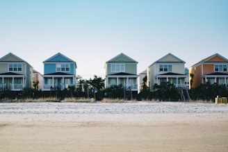 five assorted-color 2-storey houses