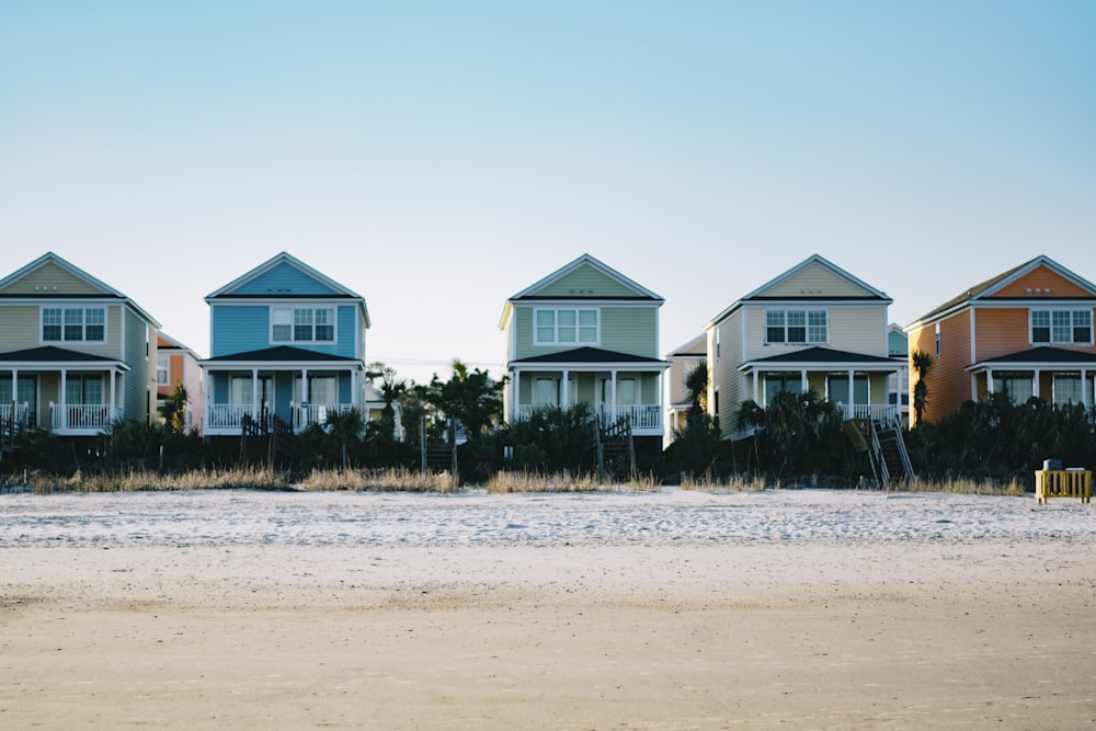 five assorted-color 2-storey houses