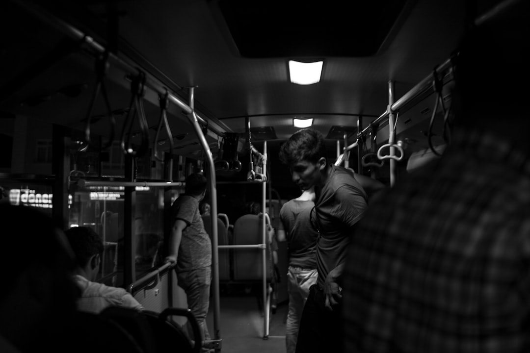 grayscale photography of people inside train