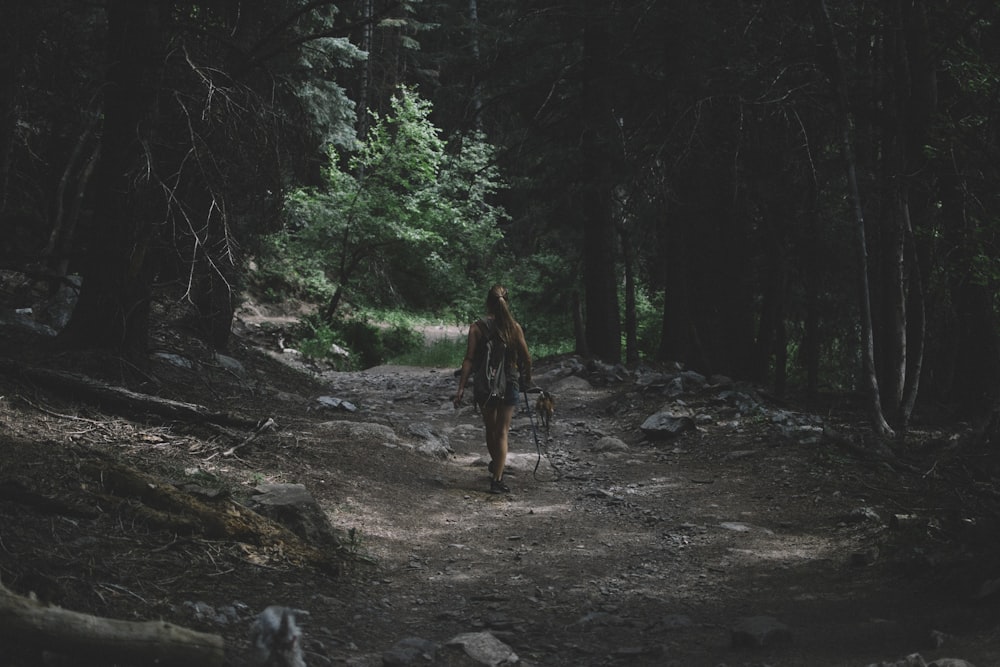 woman walking near trees