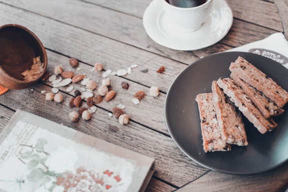 A rustic wooden table with dried fruit samples and a handwritten note.