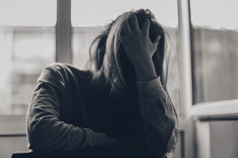 grayscale photography of person covering face