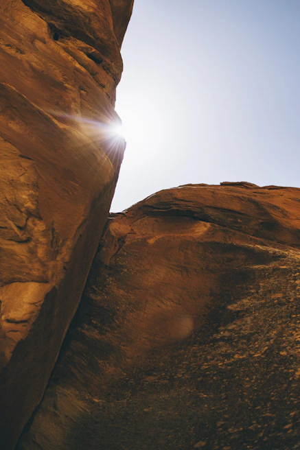 Sunlight filtering through the towering sandstone pillars of Prachov Rocks.