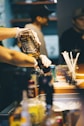 person holding black labeled bottle