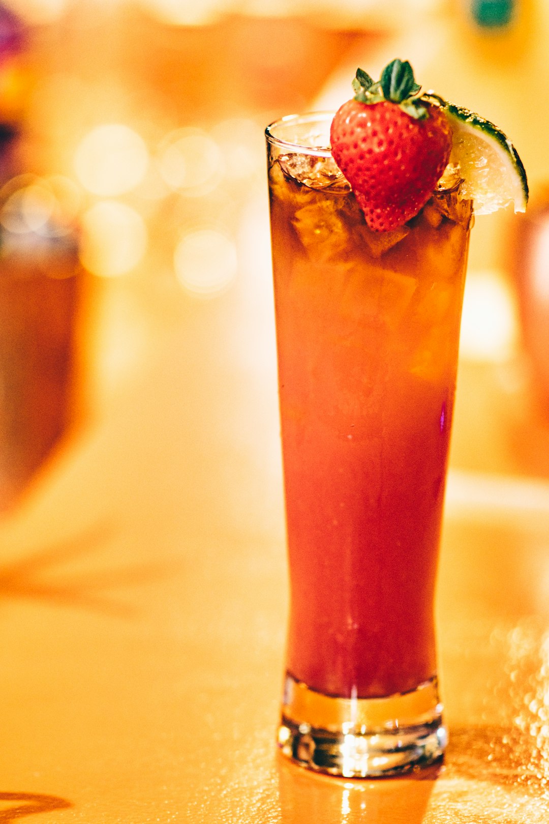 strawberry drink on glass on top of brown table