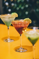 two Martini glasses with green and red liquid