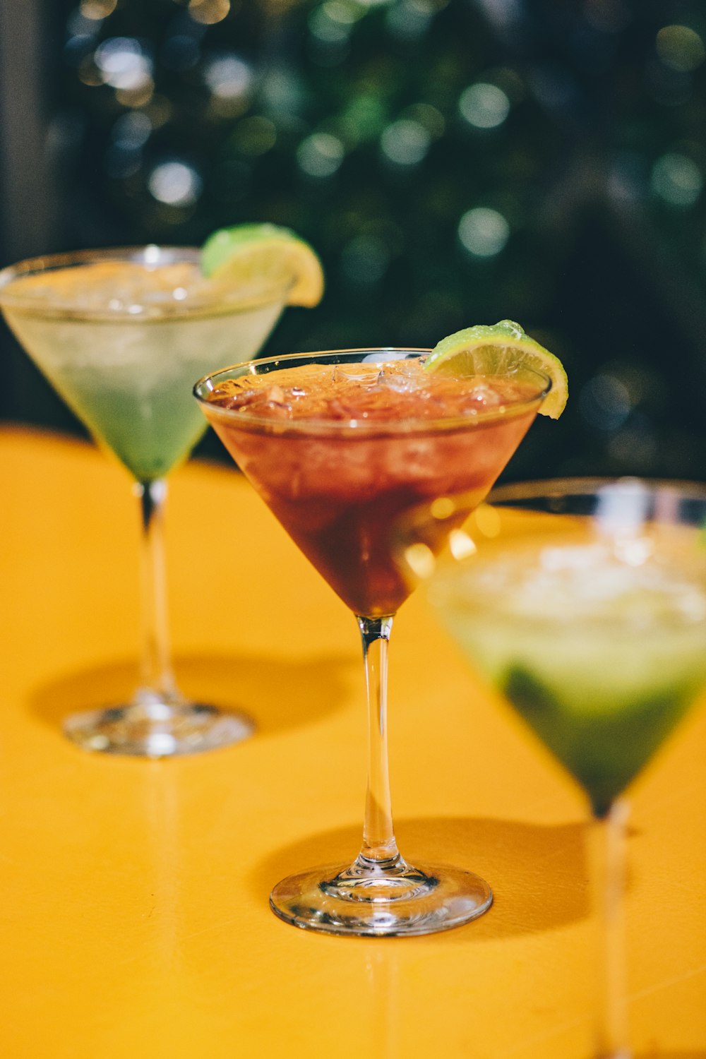 two Martini glasses with green and red liquid