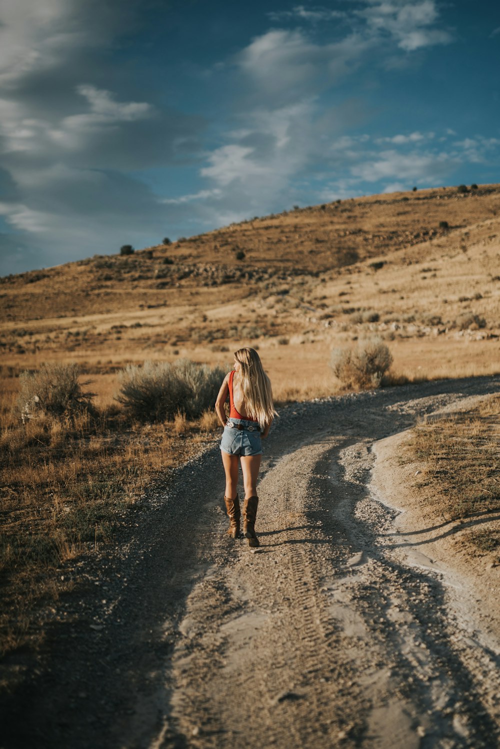 woman standing on dirt road
