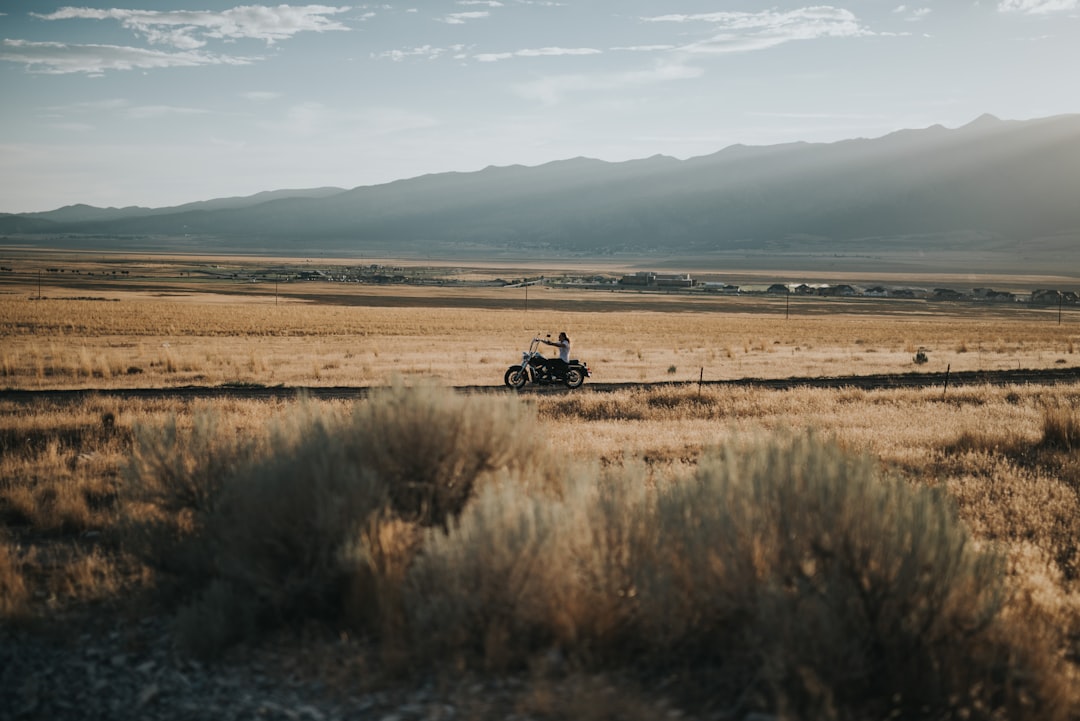 person riding cruiser motorcycle in the middle of desert