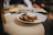 A man savoring a colorful plate of food with steam rising, inside the cozy SaborFuego restaurant.