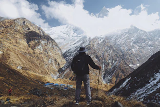 An outdoor scene with a hiker holding a Victorinox knife while admiring a mountain view