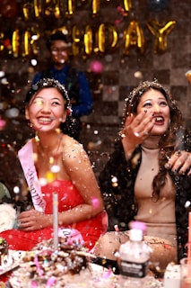 time-lapse photography of two women splashing glitters