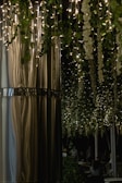 Cozy event space decorated with fairy lights and elegant drapery.