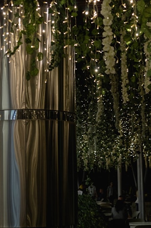 A wide-angle view of a beautifully decorated wedding venue with twinkling fairy lights.