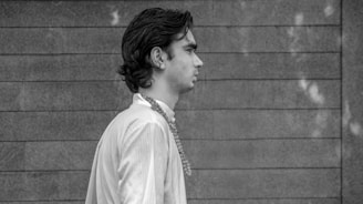 Lifestyle shot of a person walking at dusk wearing layered Atalaia amulets, blending mystery and modernity