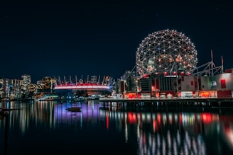 skyline photography of boat passing on waters overlooking buildings