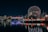 skyline photography of boat passing on waters overlooking buildings