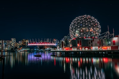 skyline photography of boat passing on waters overlooking buildings